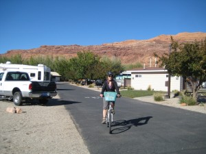 Connie biking into Portal RV Park, Moab