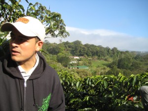 Jorge with coffee plantation behind him