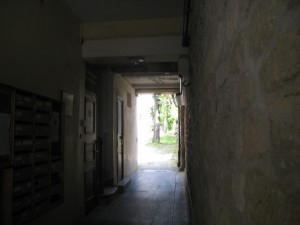 Behind entry door a passageway to courtyard