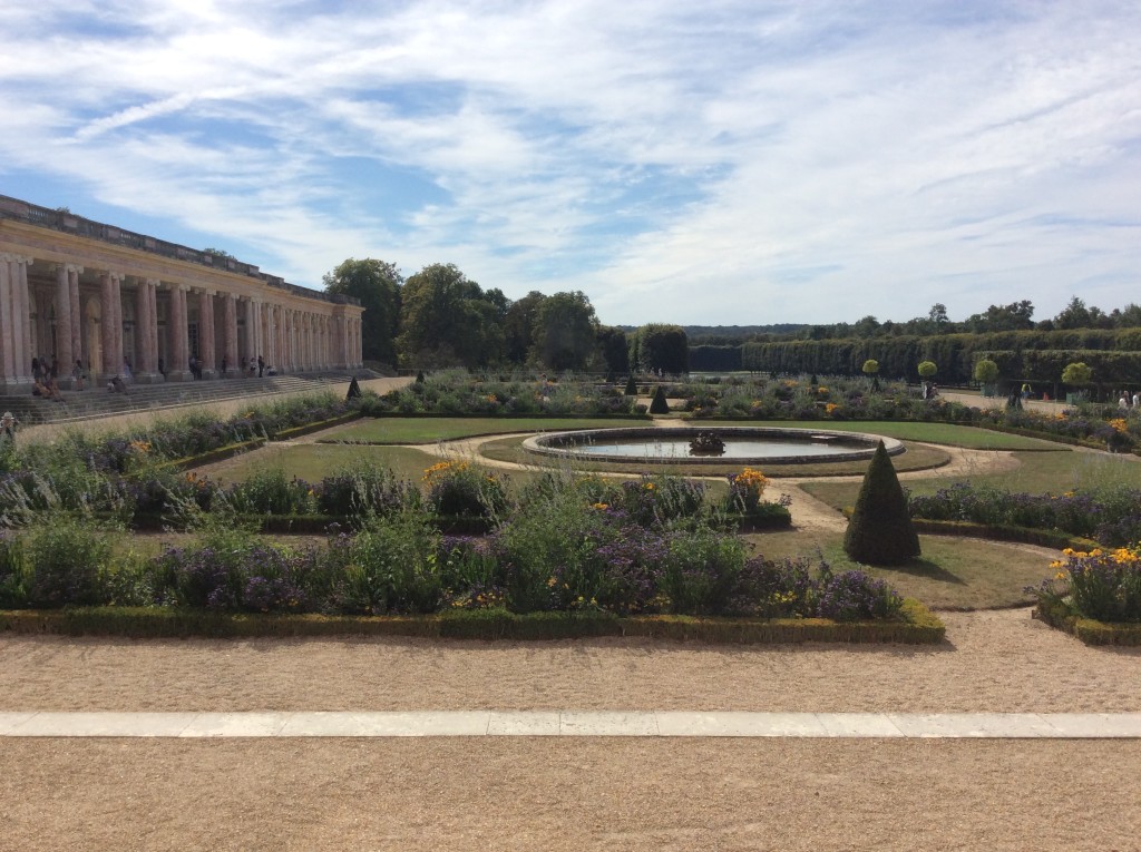 A view of the gardens from a wing of The Grand Trianon facing the walkway
